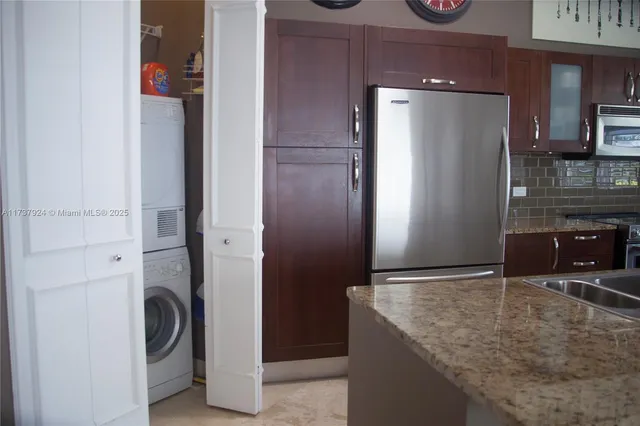 a kitchen with a refrigerator and cabinets
