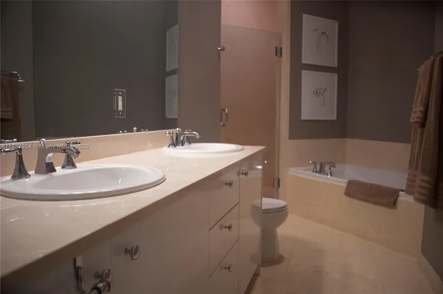 a bathroom with a double vanity sink and a bathtub