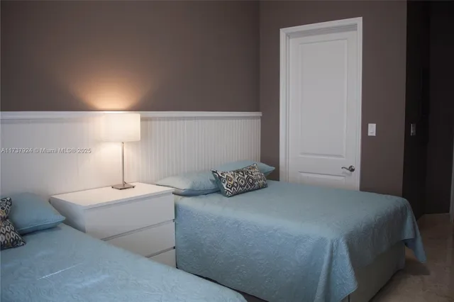 a bedroom with a bed and a lamp