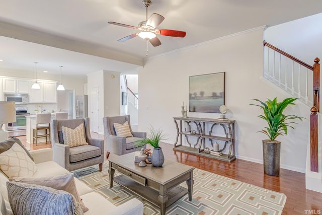 a living room with furniture potted plant and a chandelier
