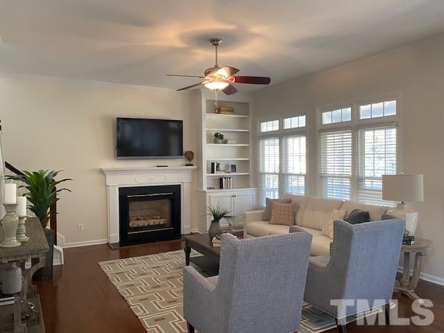 a living room with furniture a fireplace and a flat screen tv