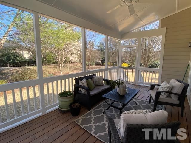 a living room with furniture and floor to ceiling windows