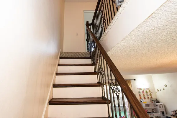 a kitchen with white cabinets and appliances