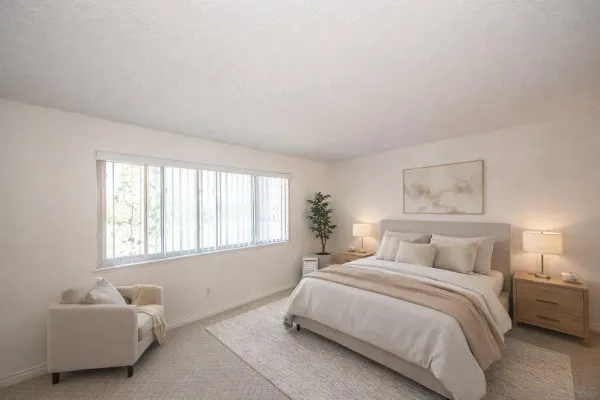 a spacious bedroom with a bed and a couch