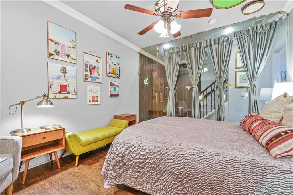 385 15th Street Northwest, Unit 6 Atlanta, GA 30363 - Photo 40 of 49 a bedroom with a bed and a chandelier