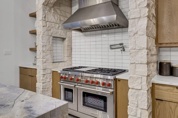 a stove top oven sitting inside of a kitchen