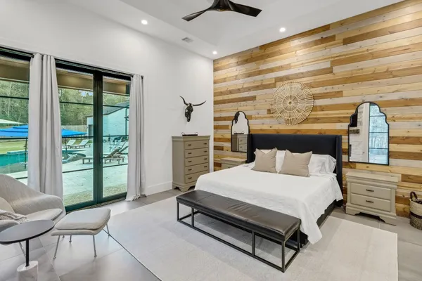 a bedroom with a bed and large window