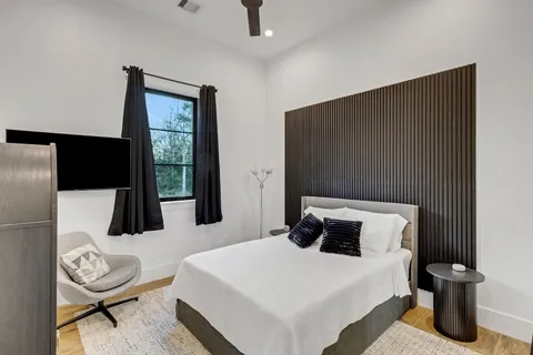 a bedroom with a bed and a table