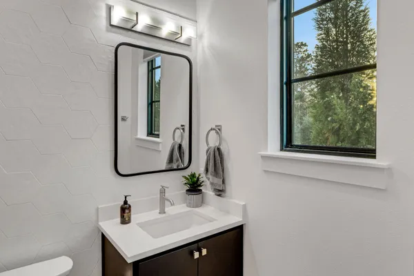 a bathroom with a sink vanity and a mirror