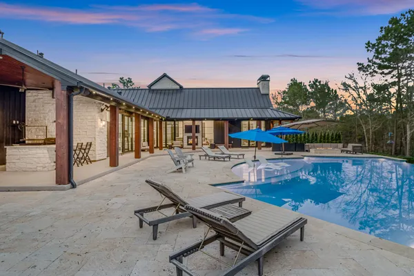a view of a patio with swimming pool table and chairs