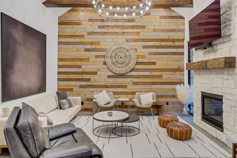 a living room with furniture a fireplace and a chandelier