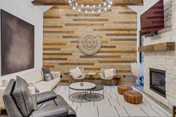 a living room with furniture a fireplace and a chandelier