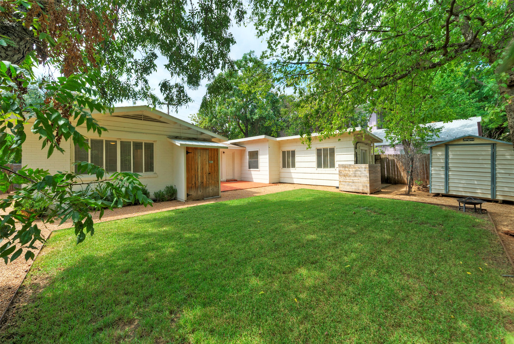 1803 Pearl Street Austin, TX 78701 - Photo 26 of 33 a view of a house with a yard and a large tree