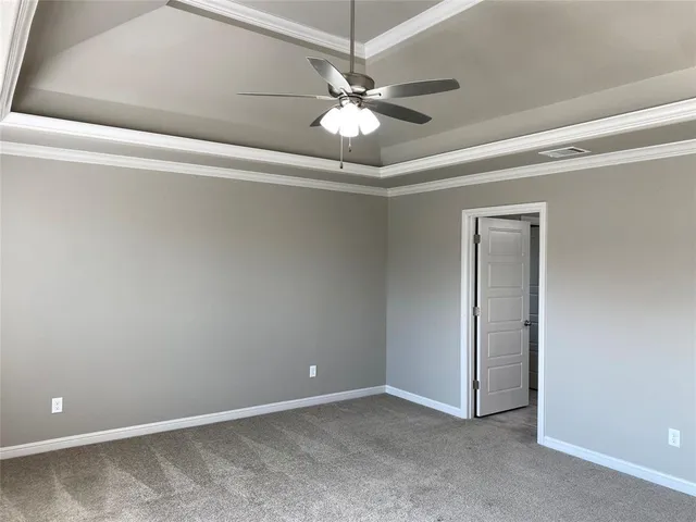 a view of an empty room with a fan