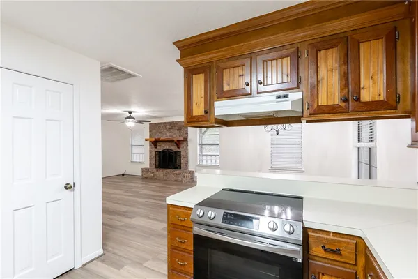 a kitchen with stainless steel appliances granite countertop a stove and a refrigerator
