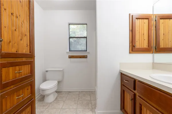 a white toilet sitting next to a bathroom sink