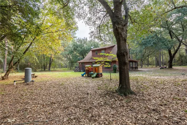 a view of a park with swings and a trees