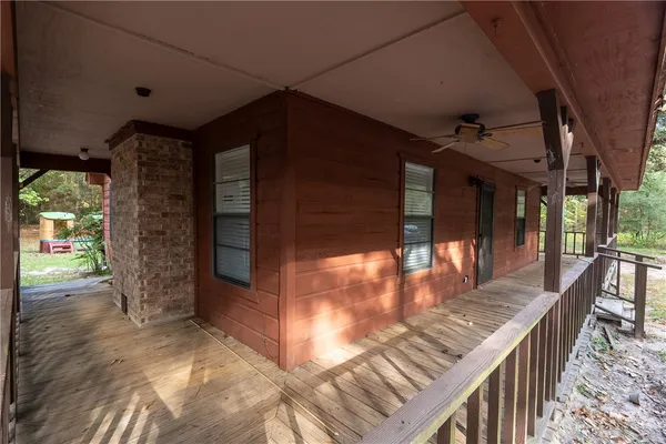 a view of a balcony with furniture and wooden floor