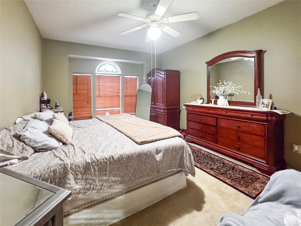 5510 Rolling Green Road Arlington, TX 76017 - Photo 11 of 19 a bedroom with a bed and a mirror on dresser