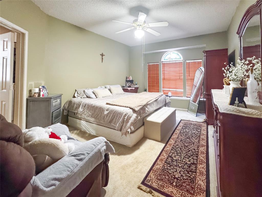 5510 Rolling Green Road Arlington, TX 76017 - Photo 12 of 19 a bedroom with furniture and a chandelier