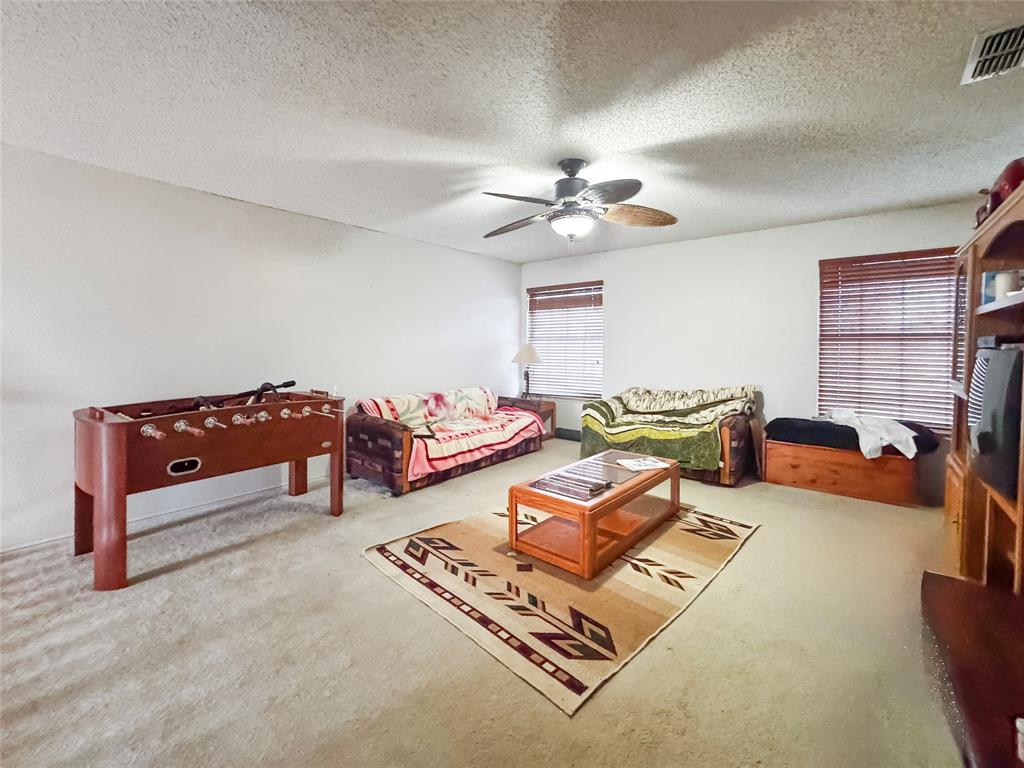 5510 Rolling Green Road Arlington, TX 76017 - Photo 13 of 19 a living room with furniture rug and a fireplace