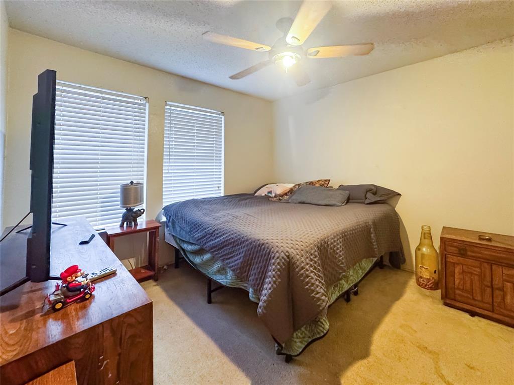 5510 Rolling Green Road Arlington, TX 76017 - Photo 14 of 19 a bedroom with a bed dresser and window