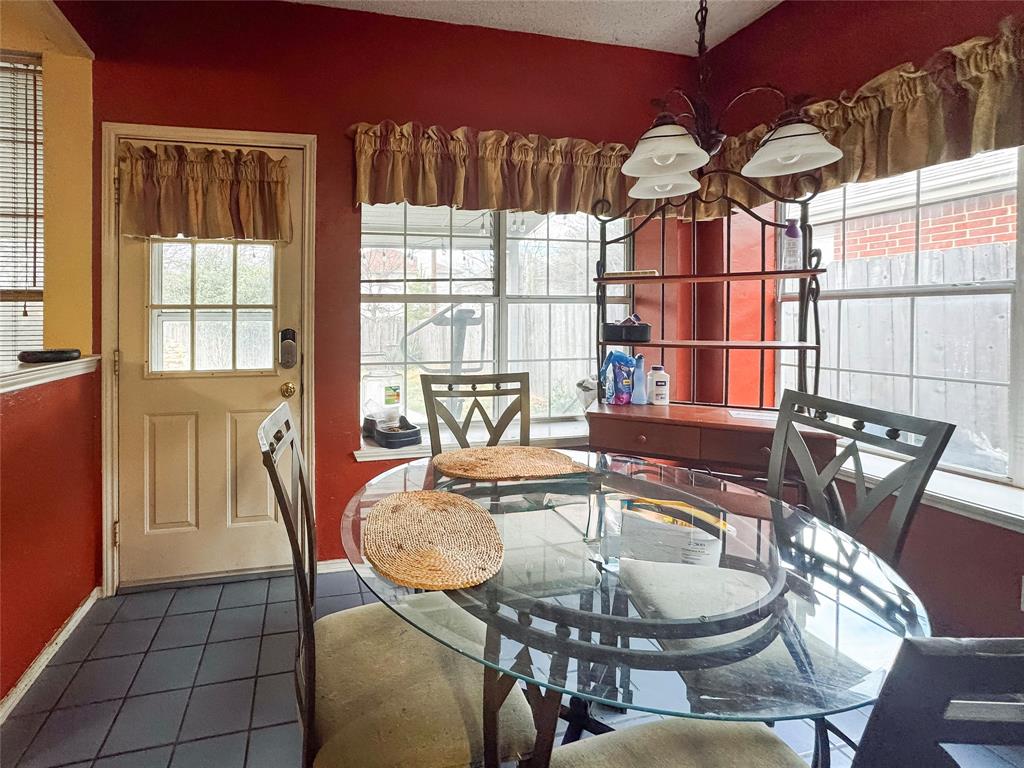 5510 Rolling Green Road Arlington, TX 76017 - Photo 10 of 19 a dining room with furniture a chandelier and window