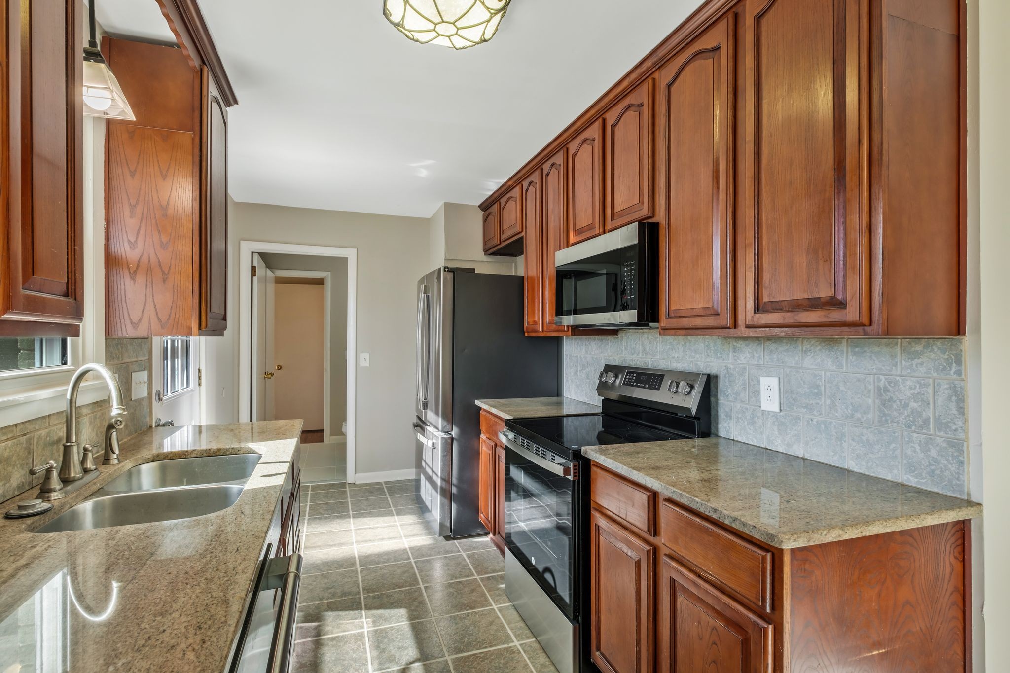 310 Santa Rosa Drive Old Hickory, TN 37138 - Photo 10 of 26 a kitchen with stainless steel appliances granite countertop a sink stove and microwave