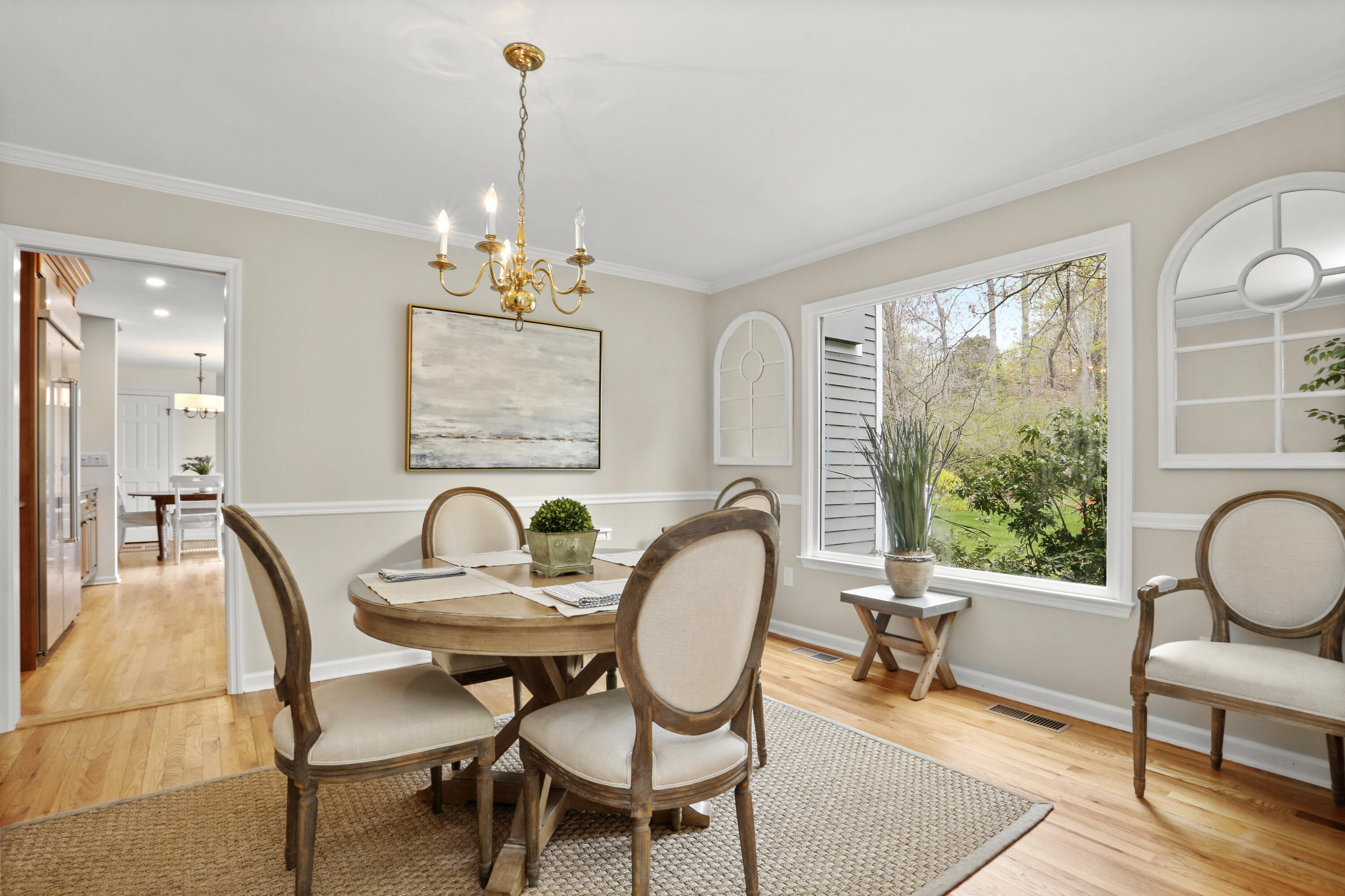 8 Ridge Farms Road Norwalk, CT 06850 - Photo 9 of 31 a dining room with furniture a rug a potted plant and a chandelier