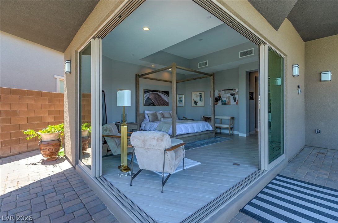 6014 Willow Ridge Court Las Vegas, NV 89135 - Photo 79 of 99 This primary bedroom opens to an inviting patio with seamless indoor-outdoor living.