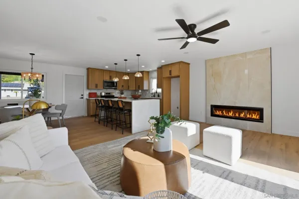 a living room with furniture and kitchen view