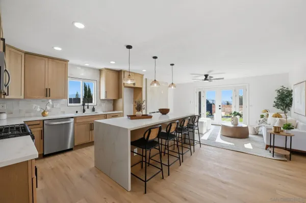 a large kitchen with cabinets table and chairs