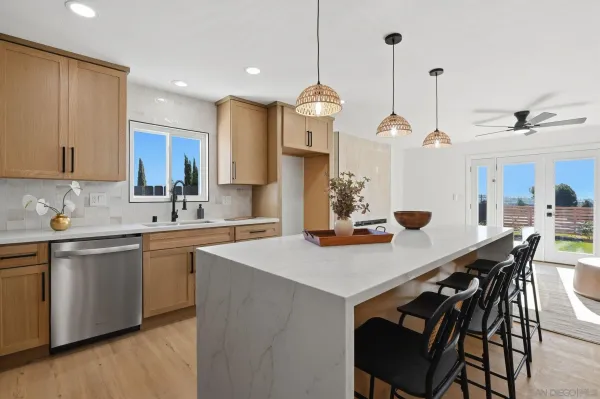 a kitchen with a table chairs sink and cabinets