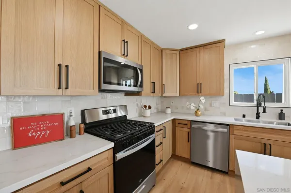 a kitchen with a sink stove top oven and cabinets