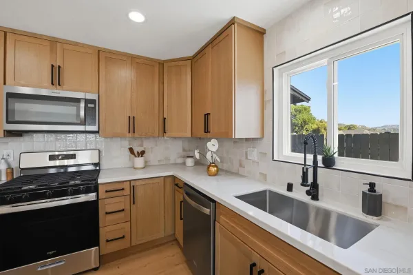 a kitchen with a sink stove and microwave