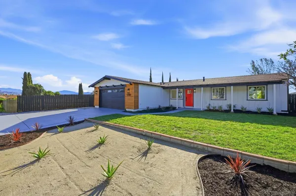 a view of a house with a yard