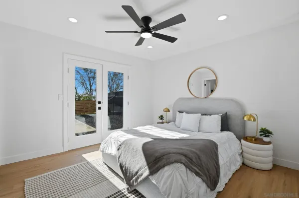 a bedroom with bed and a large window