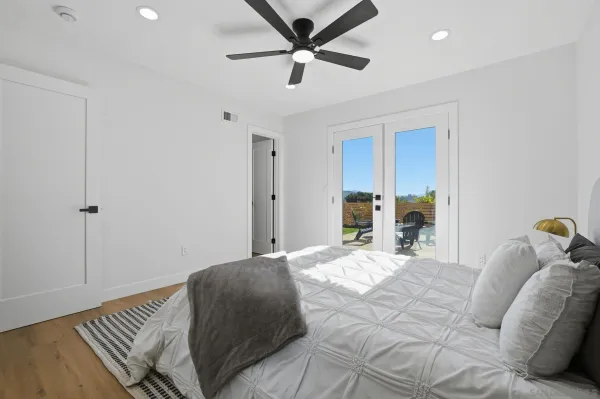 a bedroom with a large bed and a chandelier