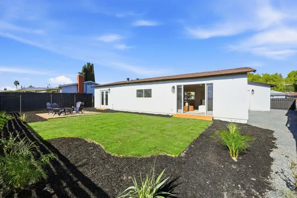 a view of a patio with a table and chairs
