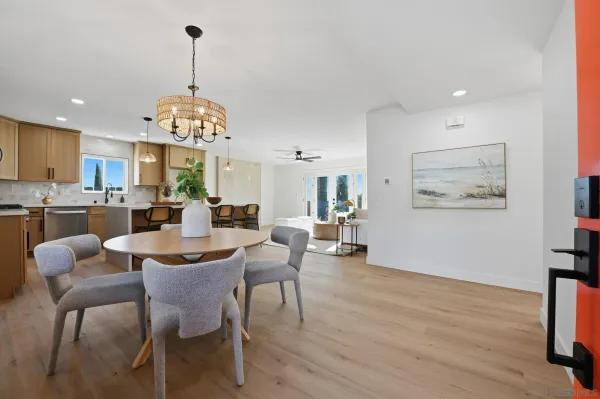 a view of a dining room with furniture wooden floor and a chandelier
