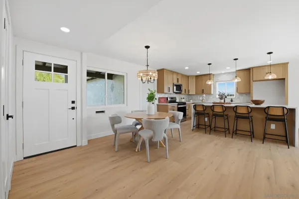 a view of a dining room with furniture and wooden floor
