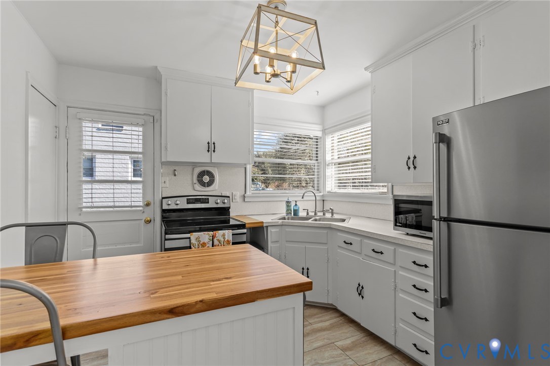 1606 Princeton Road Richmond, VA 23227 - Photo 12 of 52 a kitchen with stainless steel appliances granite countertop a stove a refrigerator a sink a stove and white cabinets