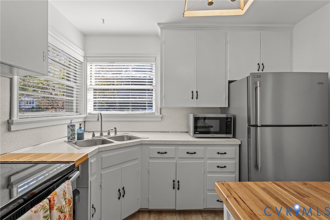 1606 Princeton Road Richmond, VA 23227 - Photo 15 of 52 a kitchen with stainless steel appliances a refrigerator sink and cabinets