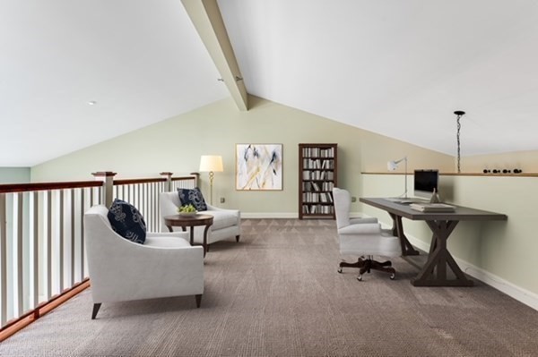 116 Milton Street, Unit 231 Dedham, MA 02026 - Photo 12 of 27 a living room with furniture and a rug