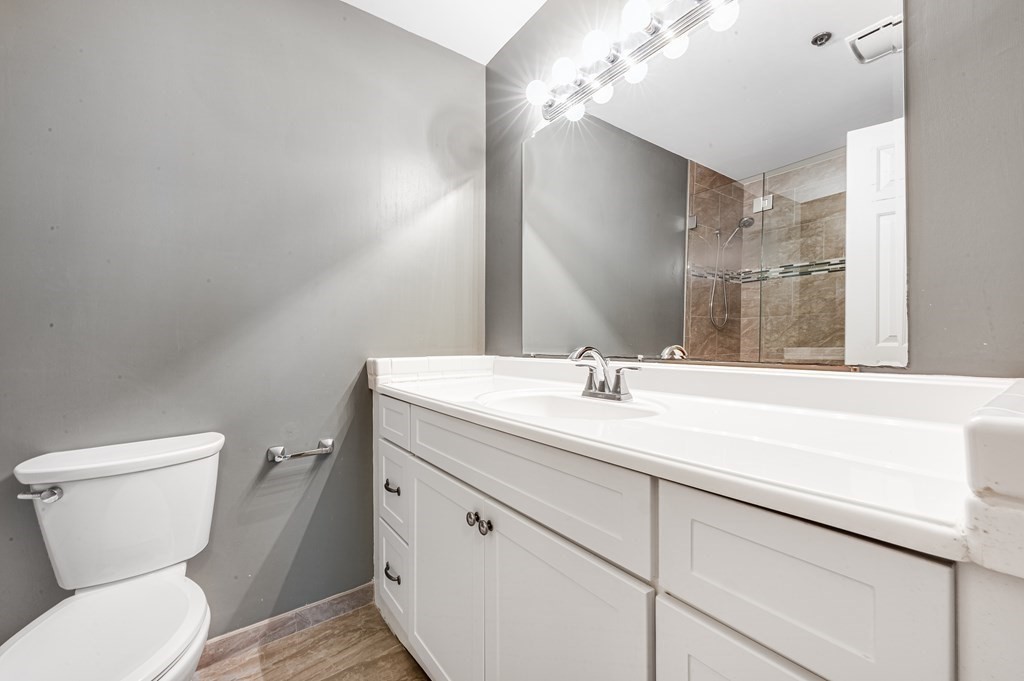 116 Milton Street, Unit 231 Dedham, MA 02026 - Photo 15 of 27 a bathroom with a toilet sink and mirror