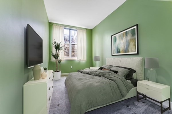 116 Milton Street, Unit 231 Dedham, MA 02026 - Photo 16 of 27 a bedroom with a bed and a flat screen tv