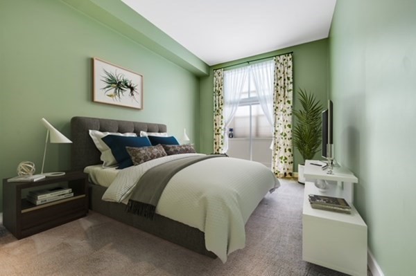 116 Milton Street, Unit 231 Dedham, MA 02026 - Photo 18 of 27 a bedroom with bed and a window