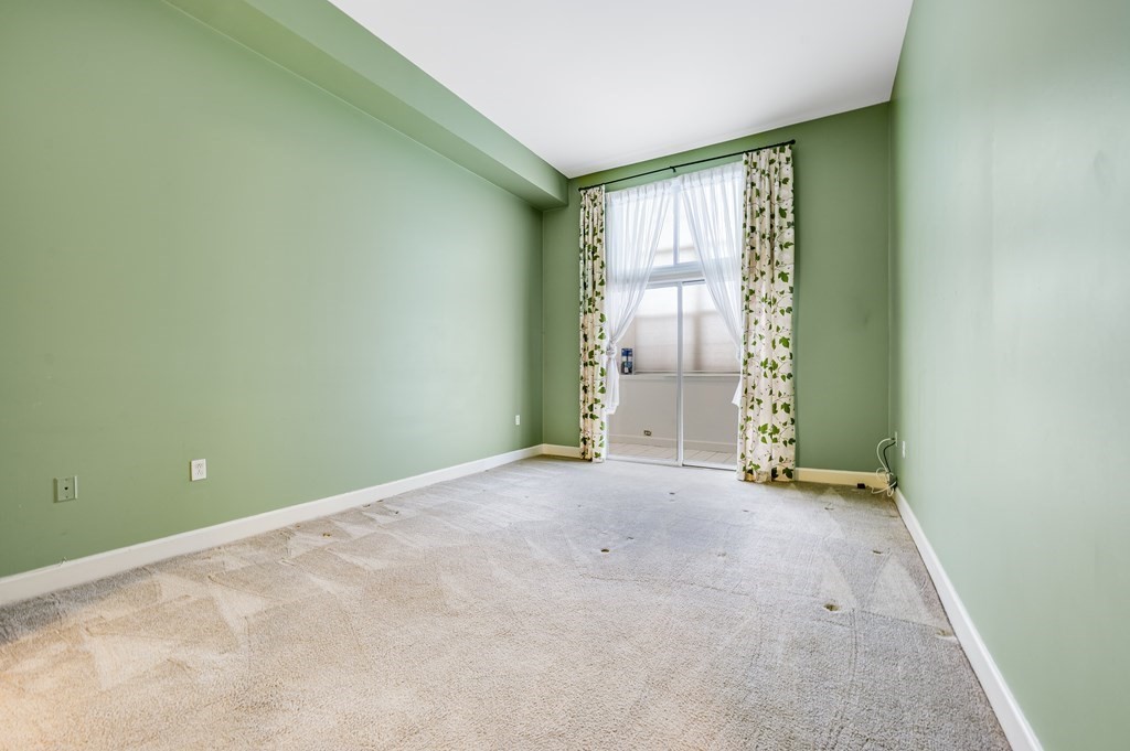 116 Milton Street, Unit 231 Dedham, MA 02026 - Photo 19 of 27 an empty room with windows
