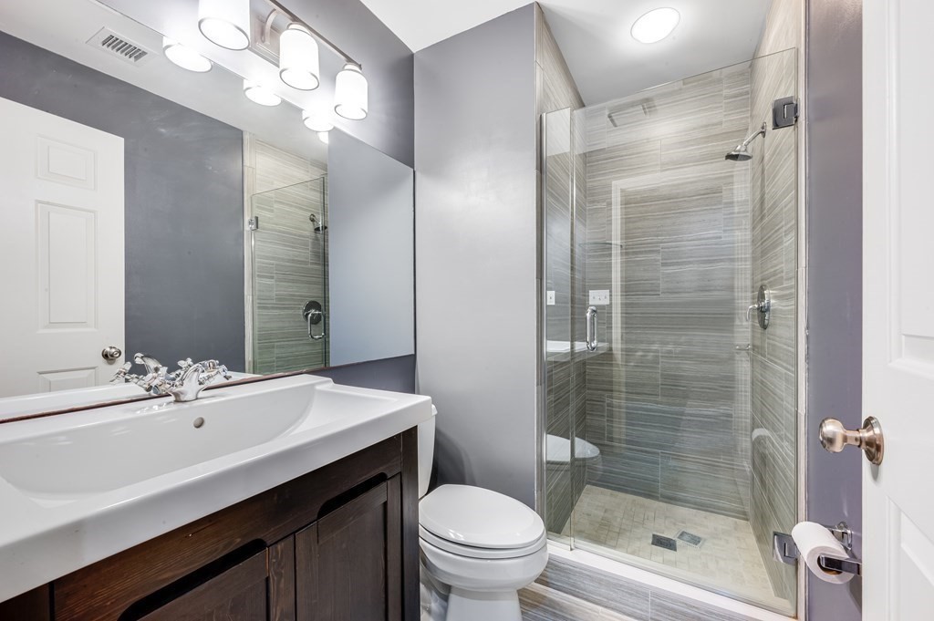 116 Milton Street, Unit 231 Dedham, MA 02026 - Photo 21 of 27 a bathroom with a sink a toilet and shower