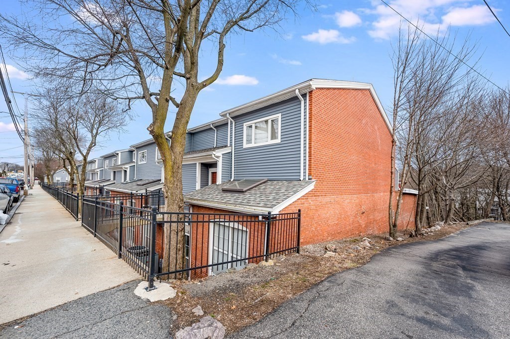 116 Milton Street, Unit 231 Dedham, MA 02026 - Photo 25 of 27 a view of a house with a large tree